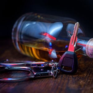 Alcohol bottle and car keys on the table. ALR Hearings In Texas. - Law Office Of Aurelio Garza PLLC